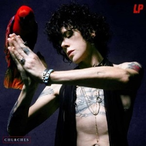 foto de LP em posição de oração com um pássaro vermelho pousado nas mãos ante um fundo escuro.